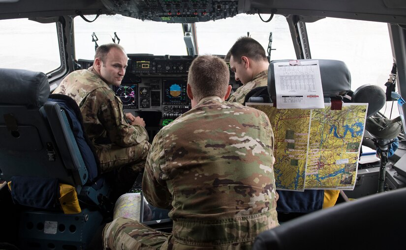 An aircrew performs preflight checks before flying a mission July 18, 2018, to test the ability to perform a Pilot-Directed Airdrop in a C-17 Globemaster III.