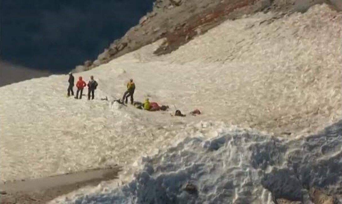A team of Reserve Citizen pararescue Airmen from the 304th Rescue Squadron, Portland, Oregon, partnered with the Oregon Army National Guard on a successful rescue of a climber who called for help atop Mount Hood in the midst of a suicide attempt, July 13. Because of the 11,000-foot altitude, the rescue was performed by ANG Chinook helicopter crew landing its two rear wheels on the mountain while a plank was used for the rescuers and climber to walk into the aircraft. The climber, was identified as a man in his 20s and was taken to a Portland-area hospital. (Courtesy photo)