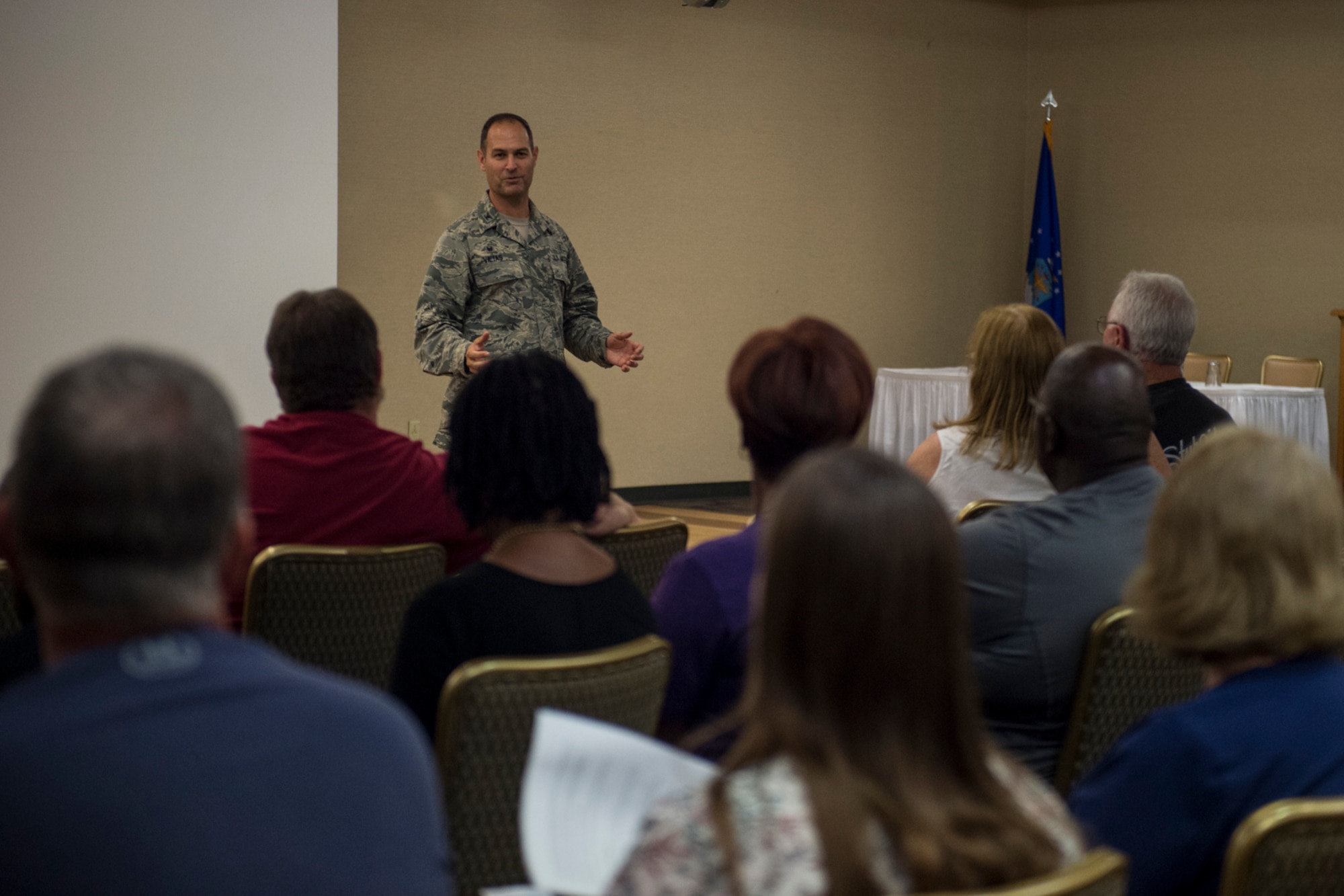 Col. Jay Vietas, 23d Medical Group commander, addresses retirees during a medical benefits town hall, July 26, 2018, at Moody Air Force Base, Ga. In order to align with a recent Air Force Medical Service policy update, the 23d Medical Group is slated to reassign approximately 1,560 retirees and their dependents to off-base TRICARE providers, on Aug. 17, 2018.