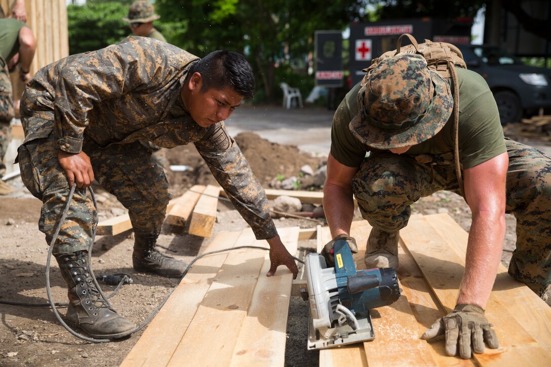 U.S. Marines work with Guatemalan engineers to build homes.