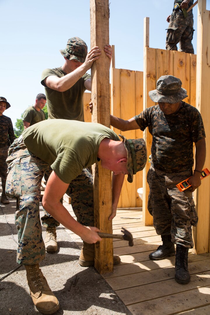 U.S. Marines work with Guatemalan engineers to build homes.
