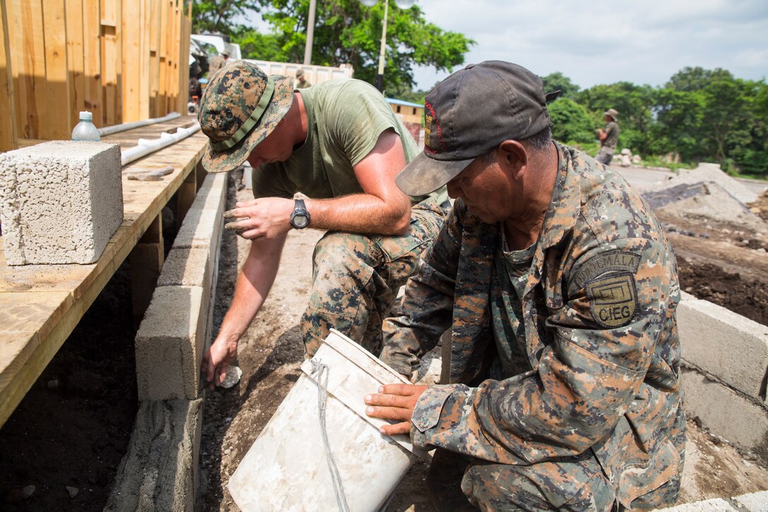 U.S. Marines work with Guatemalan engineers to build homes.