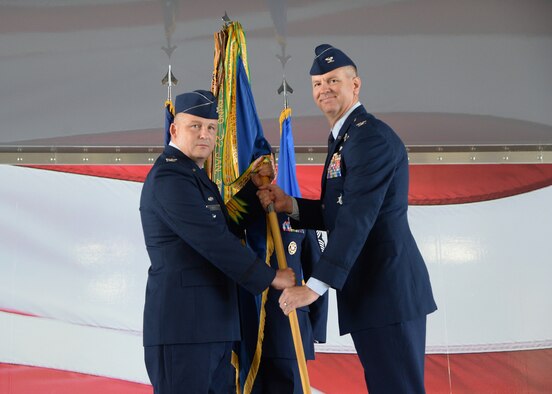 Col Travis Willis, 19th Air Force Vice Wing Commander hands the 12th Flying Training Wing flag to Col. Mark Robinson during his assumption of command July 27, 2018.