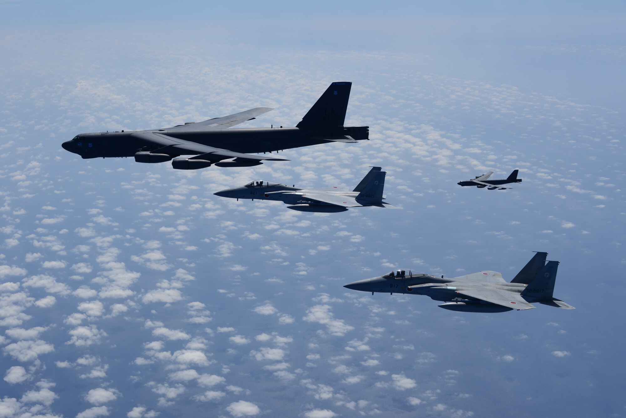 Two U.S. Air Force B-52H Stratofortress bombers and two Koku Jieitai (Japan Air Self-Defense Force) F-15 fighters execute a routine bilateral training mission in the vicinity of Japan, July 26, 2018.  This mission was flown in support of U.S. Indo-Pacific Command’s Continuous Bomber Presence (CBP) operations, which are a key component to improving combined and joint service interoperability. Bilateral training missions such as this allow the two countries to improve upon combined capabilities, tactical skills, and relationships. (Courtesy Photo)