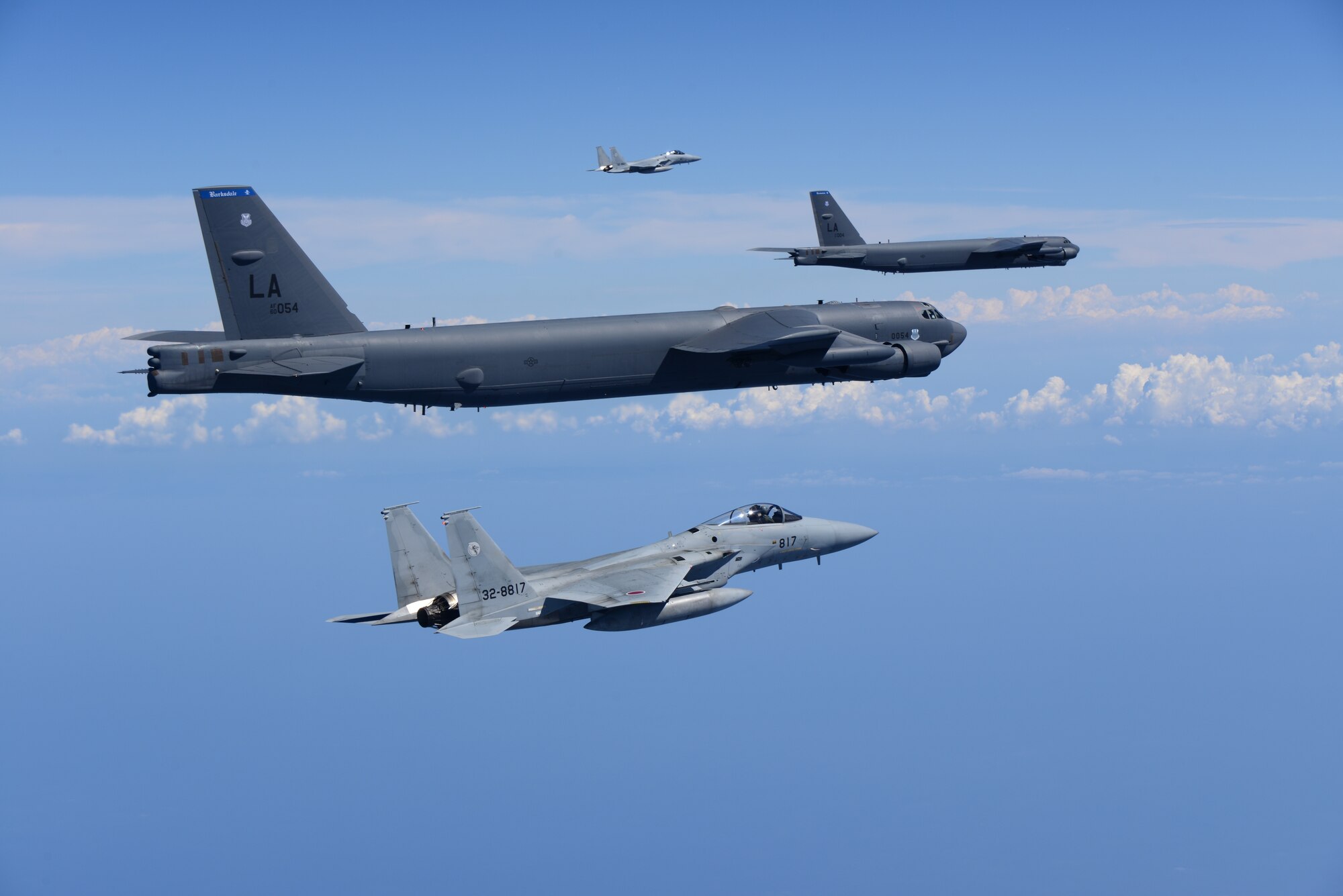 Two U.S. Air Force B-52H Stratofortress bombers and two Koku Jieitai (Japan Air Self-Defense Force) F-15 fighters execute a routine bilateral training mission in the vicinity of Japan, July 26, 2018. This mission was flown in support of U.S. Indo-Pacific Command’s Continuous Bomber Presence (CBP) operations, which are a key component to improving combined and joint service interoperability. Bilateral training missions such as this allow the two countries to improve upon combined capabilities, tactical skills, and relationships. (Courtesy Photo)