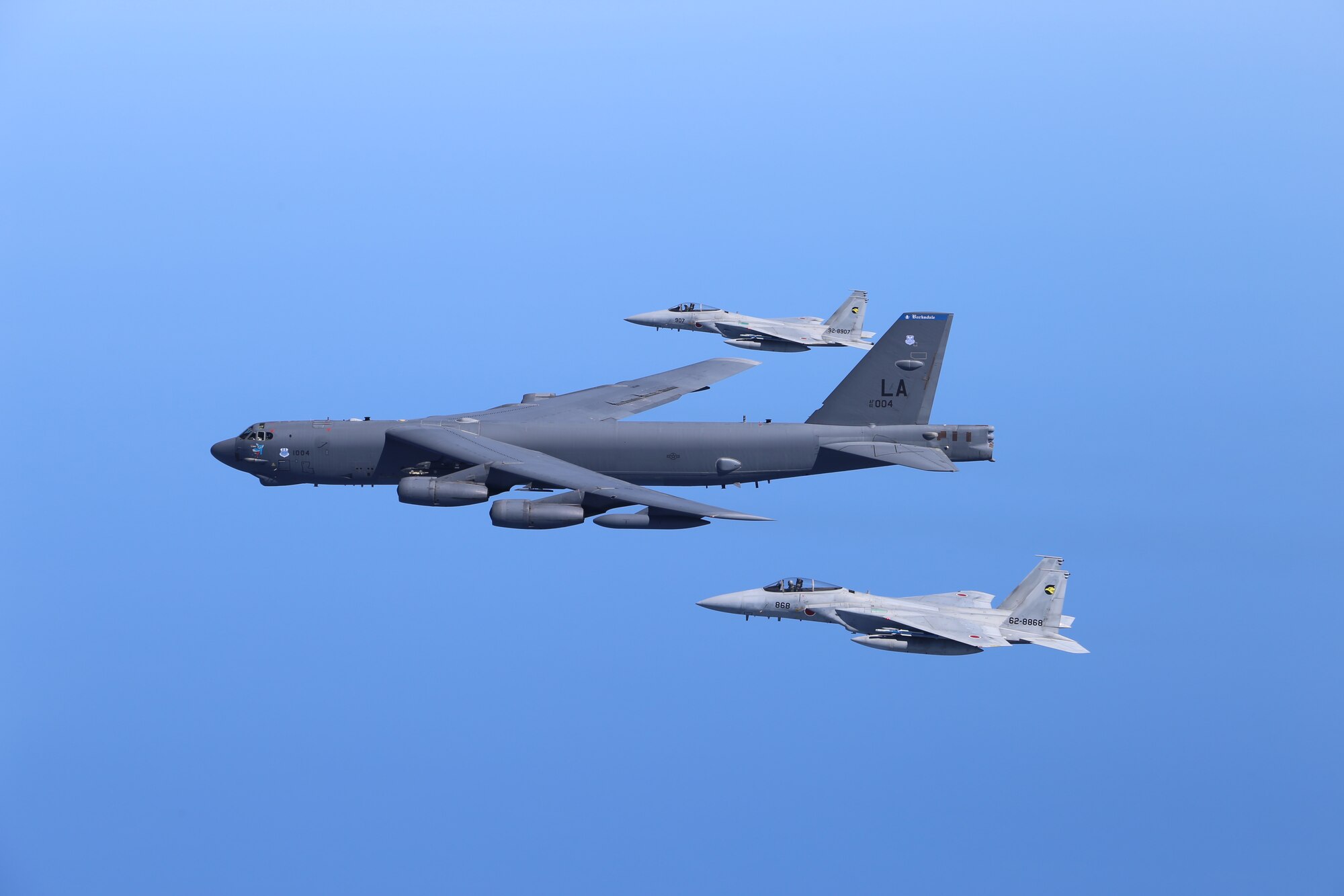 One U.S. Air Force B-52H Stratofortress bombers and two Koku Jieitai (Japan Air Self-Defense Force) F-15 fighters execute a routine bilateral training mission in the vicinity of Japan, July 26, 2018. This mission was flown in support of U.S. Indo-Pacific Command’s Continuous Bomber Presence (CBP) operations, which are a key component to improving combined and joint service interoperability. Bilateral training missions such as this allow the two countries to improve upon combined capabilities, tactical skills, and relationships. (Courtesy Photo)