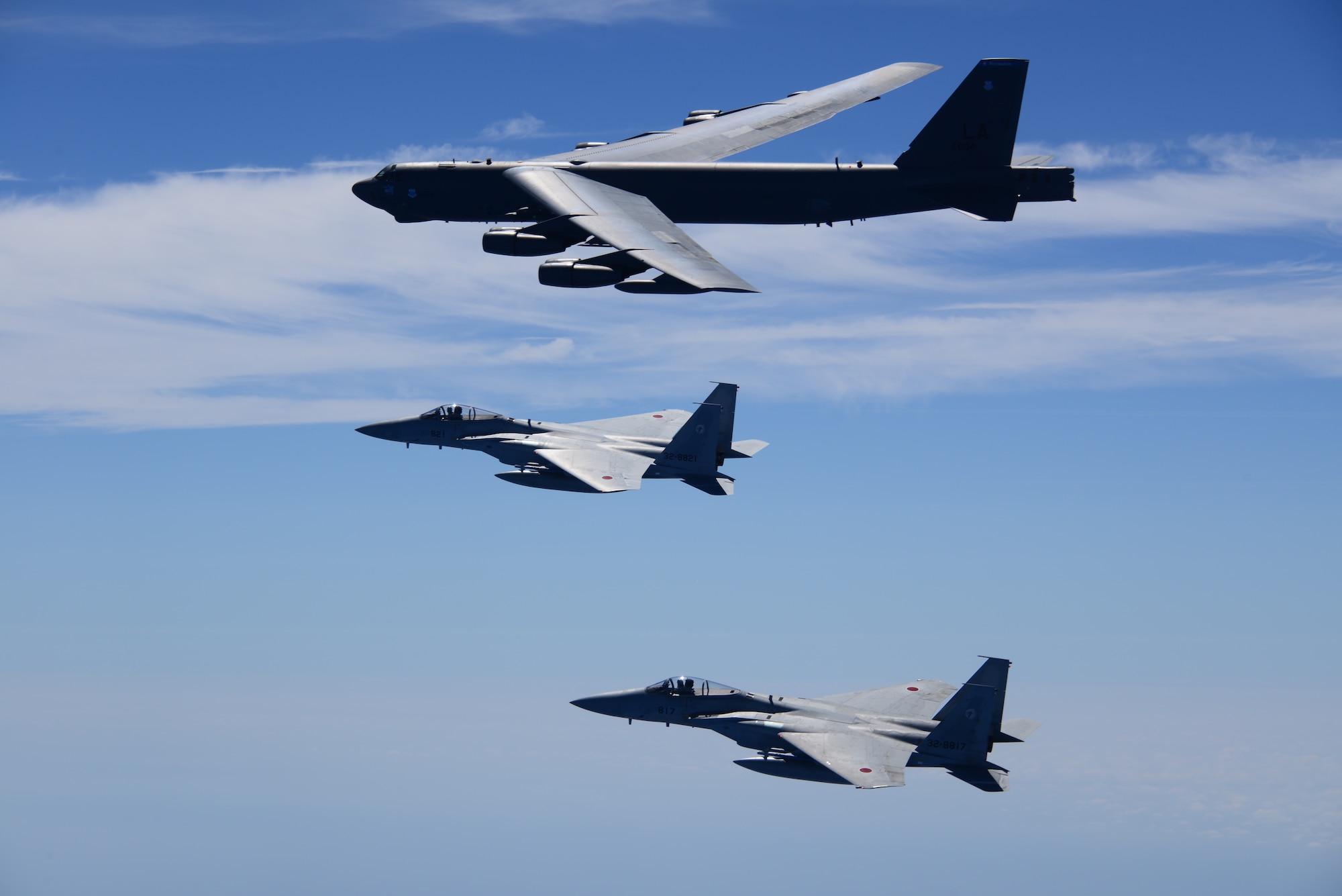 One U.S. Air Force B-52H Stratofortress bombers and two Koku Jieitai (Japan Air Self-Defense Force) F-15 fighters execute a routine bilateral training mission in the vicinity of Japan, July 26, 2018. This mission was flown in support of U.S. Indo-Pacific Command’s Continuous Bomber Presence (CBP) operations, which are a key component to improving combined and joint service interoperability. Bilateral training missions such as this allow the two countries to improve upon combined capabilities, tactical skills, and relationships. (Courtesy Photo)