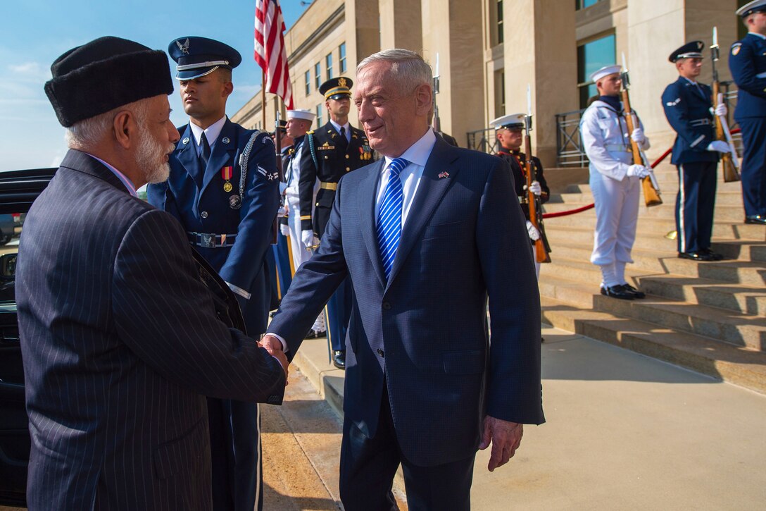 Defense Secretary James N. Mattis shakes hands with Oman's foreign minister.