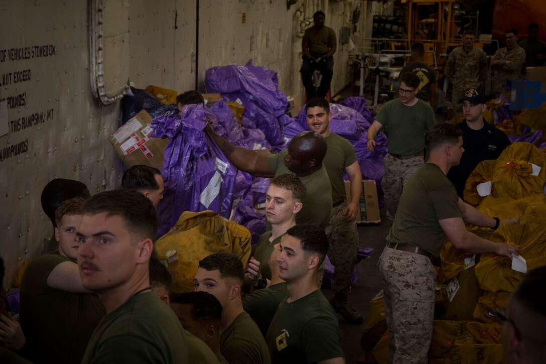 MEDITERRANEAN SEA (May 15, 2018) Marines and Sailors aboard the San Antonio-class amphibious transport dock USS New York (LPD 21) organize mail May 15, 2018. The New York receives mail during replenishments-at-sea and in port while deployed to the U.S. 6th Fleet area of operations. U.S. 6th Fleet, headquartered in Naples, Italy, conducts the full spectrum of joint and naval operations, often in concert with allied and interagency partners, in order to advance U.S. national interests and security and stability in Europe and Africa. (U.S. Marine Corps photo by Cpl. Juan A. Soto-Delgado/Released)