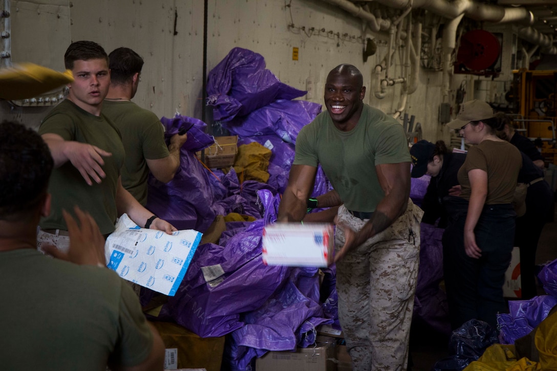 MEDITERRANEAN SEA (May 15, 2018) Marines and Sailors aboard the San Antonio-class amphibious transport dock USS New York (LPD 21) organize mail May 15, 2018. The New York receives mail during replenishments-at-sea and in port while deployed to the U.S. 6th Fleet area of operations. U.S. 6th Fleet, headquartered in Naples, Italy, conducts the full spectrum of joint and naval operations, often in concert with allied and interagency partners, in order to advance U.S. national interests and security and stability in Europe and Africa. (U.S. Marine Corps photo by Cpl. Juan A. Soto-Delgado/Released)