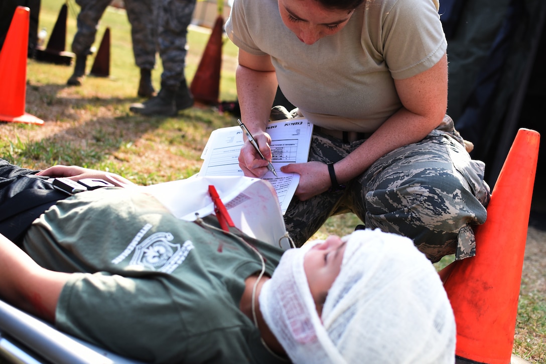 Air Force Reservist Capt. Mary Wellman, an emergency room nurse assigned to the 301st Medical Squadron, admits a patient into the simulated field hospital July 28, 2018, during a mass casualty exercise at Naval Air Station Fort Worth Joint Reserve Base, Texas. Members from the 301st Fighter Wing Medical Squadron, Emergency Medical Facility Dallas 1, NAS Fort Worth JRB Fire Department, Marine Air Control Squadron 24 and MedStar practiced their critical medical skills and strengthened joint partnerships. Texas Wing Group VI Civil Air Patrol participated as patients. (U.S. Air Force photo by Maj. Candice Allen)