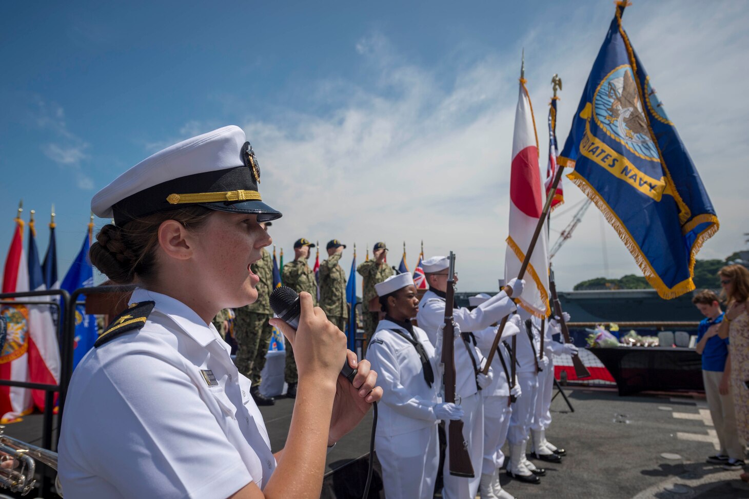 YOKOSUKA, Japan (July 27, 2018) Ensign Katherine Lindman, from Minneapolis, Minnesota, sings the national anthem on the flight deck aboard the Ticonderoga-class guided-missile cruiser USS Chancellorsville (CG 62) during a change of command ceremony where Capt. Wilson Marks is relieved by Capt. Marc D. Boran as the ship’s commanding officer. Chancellorsville is forward-deployed to the U.S. 7th Fleet area of operations in support of security and stability in the Indo-Pacific region.