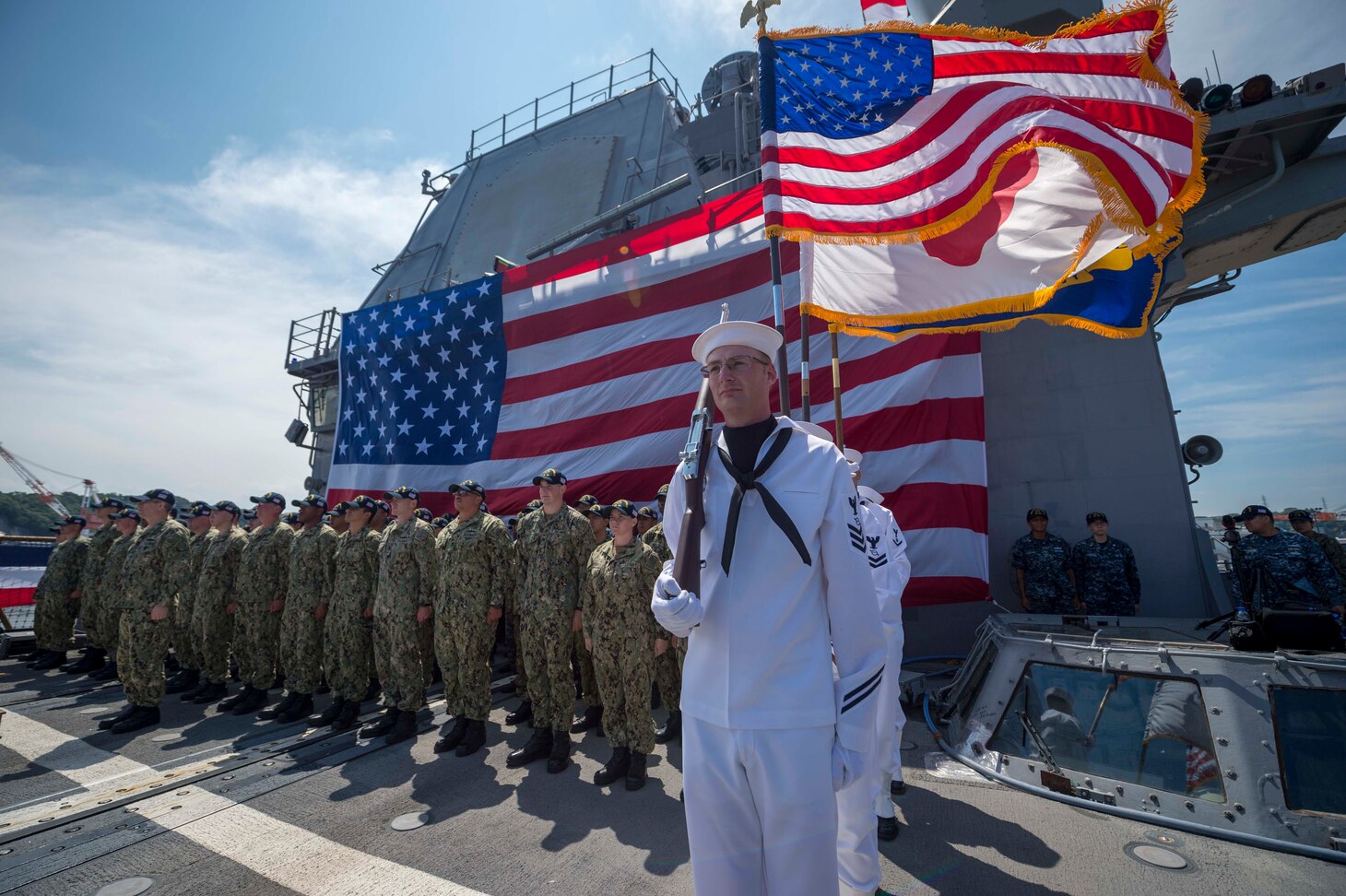 YOKOSUKA, Japan (July 27, 2018) Sailors, aboard the Ticonderoga-class guided-missile cruiser USS Chancellorsville (CG 62), stand at attention on the ship’s flight deck during a change of command ceremony where Capt. Wilson Marks is relieved by Capt. Marc D. Boran as the ship’s commanding officer. Chancellorsville is forward-deployed to the U.S. 7th Fleet area of operations in support of security and stability in the Indo-Pacific region.