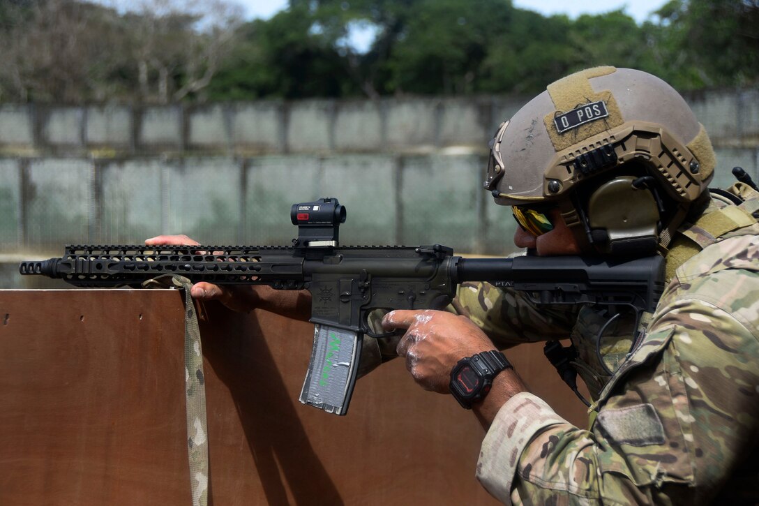 A U.S. Army Green Beret takes aim firing his weapon at targets.