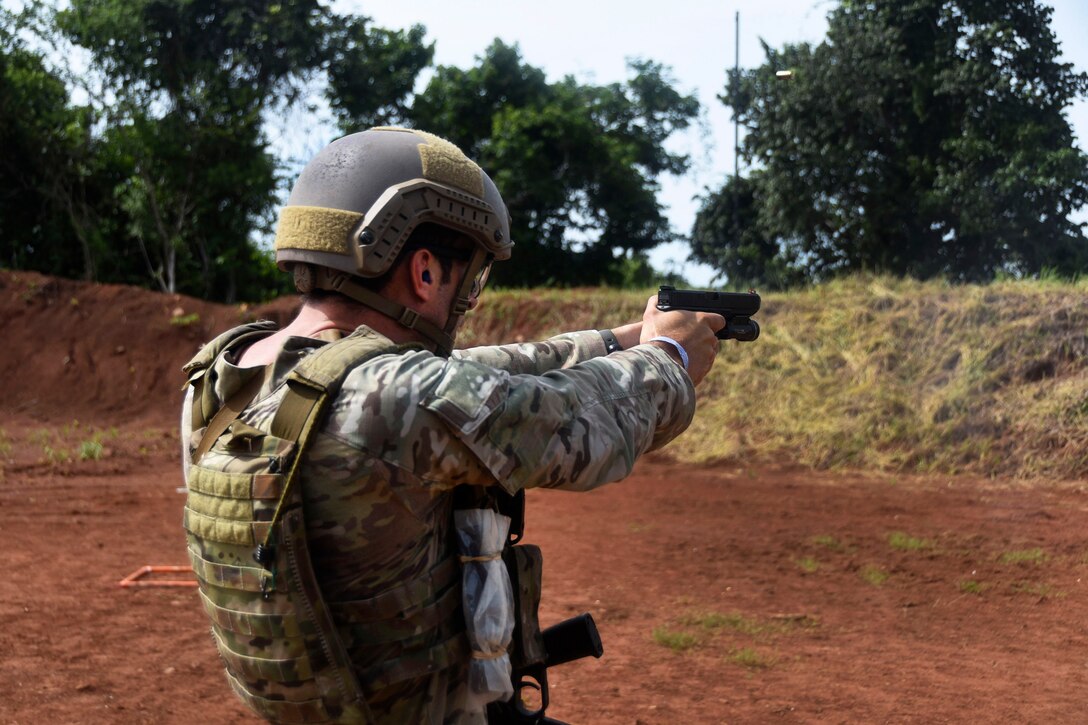 A U.S. Army Green Beret fires his handgun at targets on the assault range.