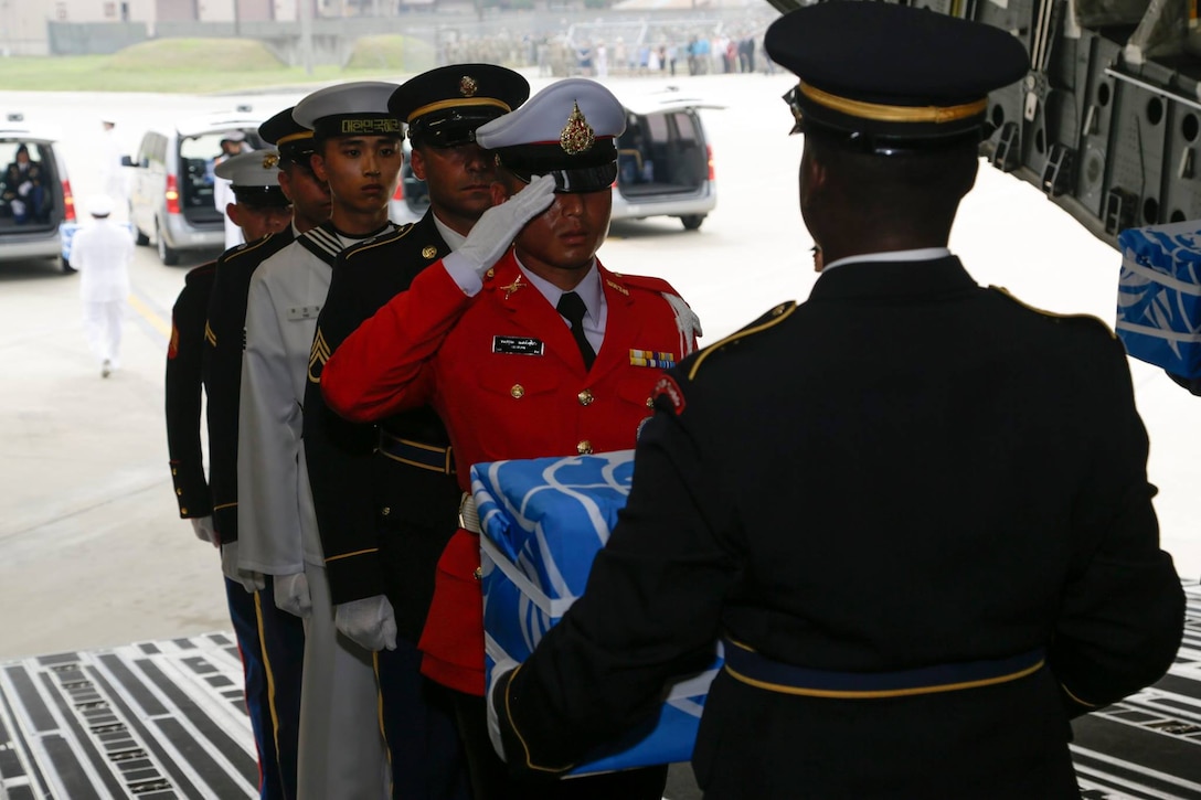 United Nations Honor Guard members carry the remains during a dignified return ceremony at Osan Air Base, Republic of Korea, Friday.
