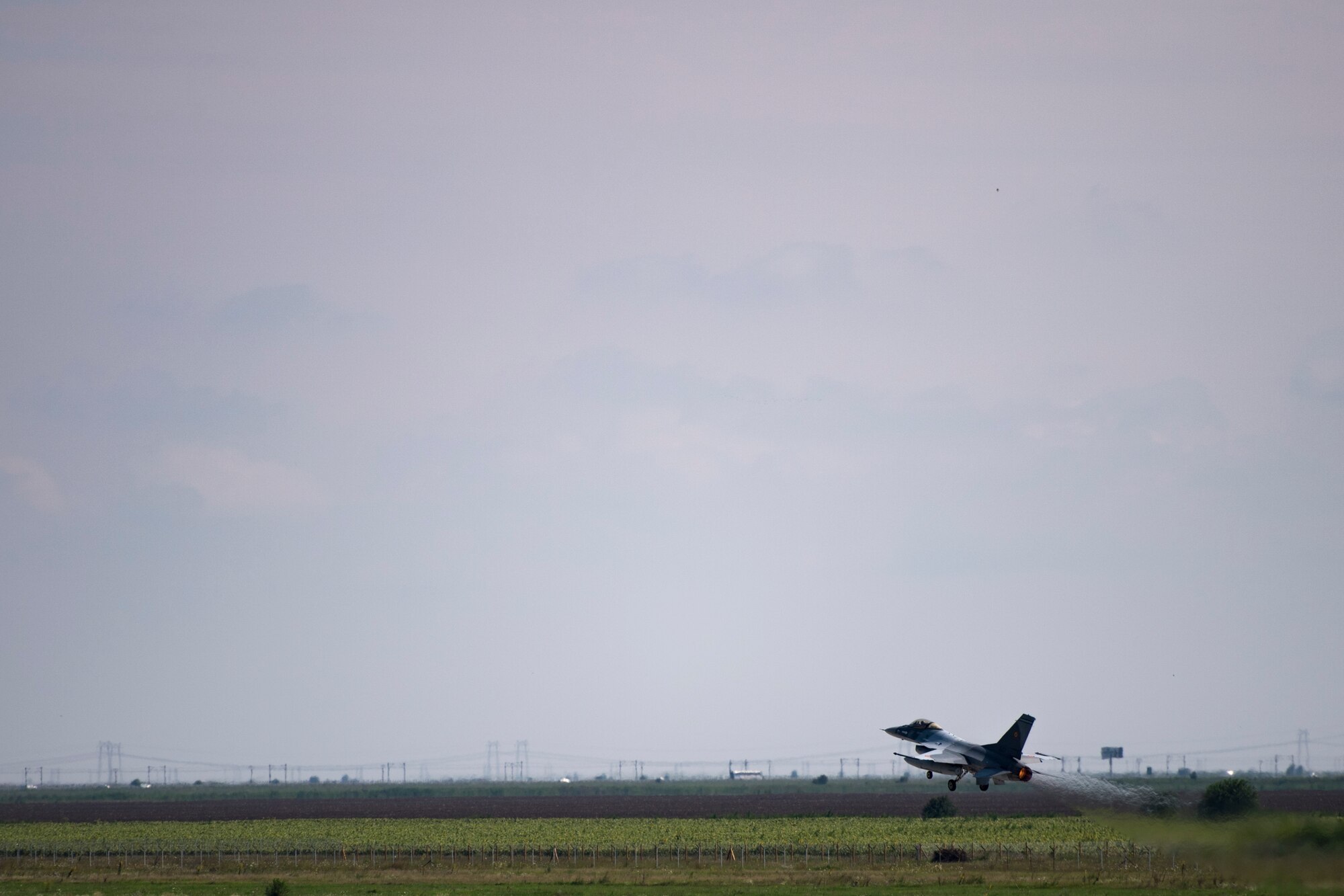 A Romanian air force pilot takes off in an F-16 Fighting Falcon on Borcea Air Base, Romania, July 26, 2018. The Romanian air force obtained the F-16s in 2016. U.S. Air Force maintenance personnel visited Borcea to provide visual aid and share aircraft maintenance processes with the Romanians as part of a three-week engagement. (U.S. Air Force photo by Senior Airman Devin Boyer)