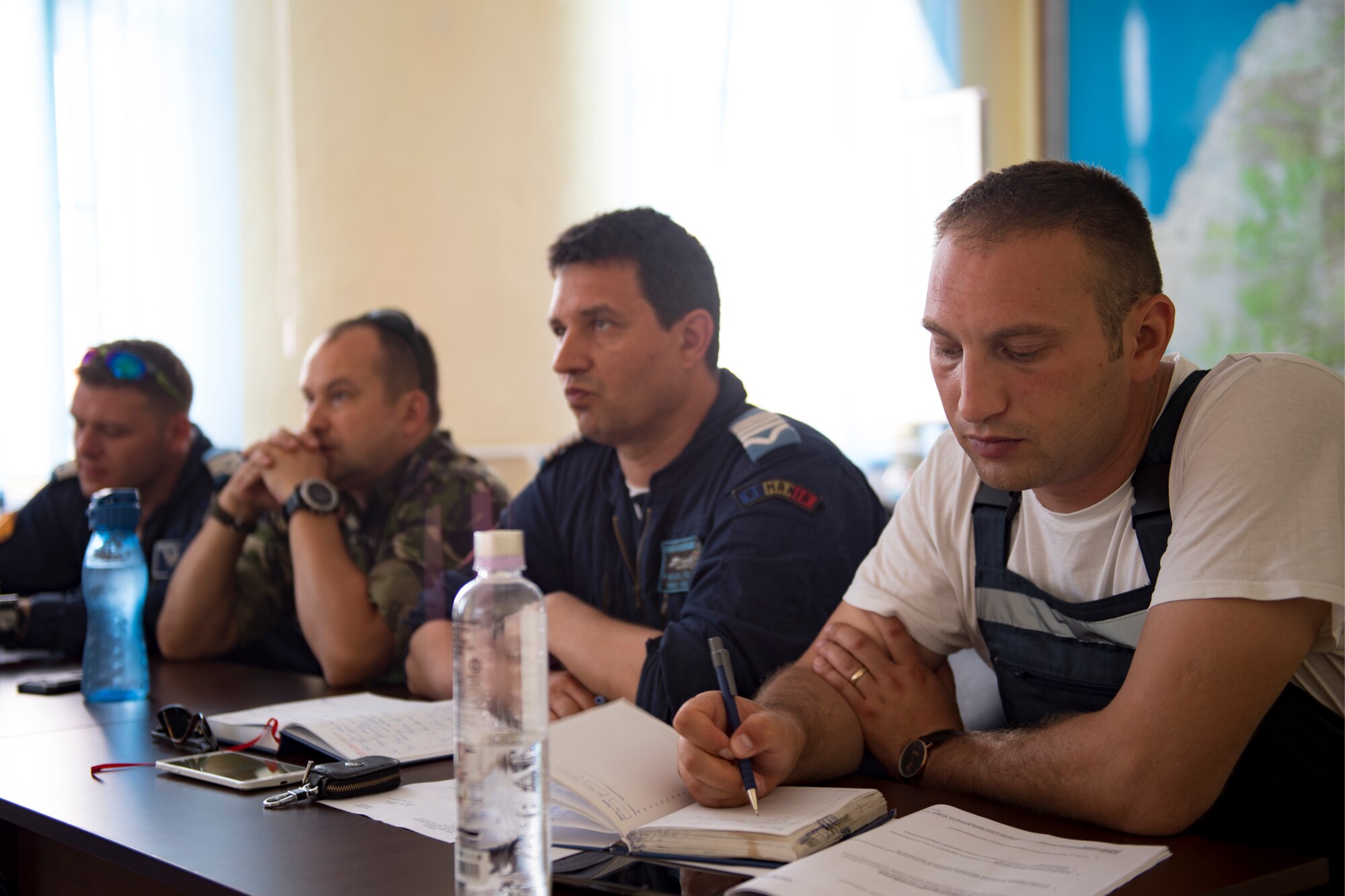 Romanian air force personnel attend a training session with U.S. Air Force supply experts during a three-week engagement on Borcea Air Base, Romania, July 24, 2018. The supply Airmen shared their experiences with the Romanians to give them a different perspective of processes and procedures. (U.S. Air Force photo by Senior Airman Devin Boyer)