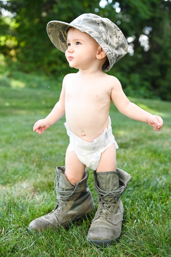 Hannah Kobily tries on her mother’s boots and cap in Oakdale, Pennsylvania, July 26, 2018. Hannah is one week away from her first birthday. (U.S. Air Force photo by Senior Airman Beth Kobily)