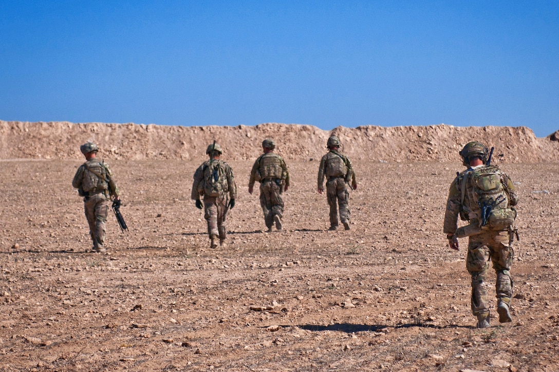 U.S. soldier maneuver toward a coordination point to link up with Turkish soldiers.