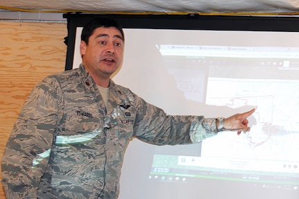 U.S. Air Force Maj. Nicholas Edwards, an intelligence analyst manager with the California Air National Guard’s 195th Air Base Wing, updates leaders from the California Department of Forestry and Fire Protection (CAL FIRE) on the Carr Fire in Shasta County, California. Edwards leads a team that gives accurate information CAL FIRE uses to battle the Carr Fire that intensified to nearly 90,000 burned acres in about a week.