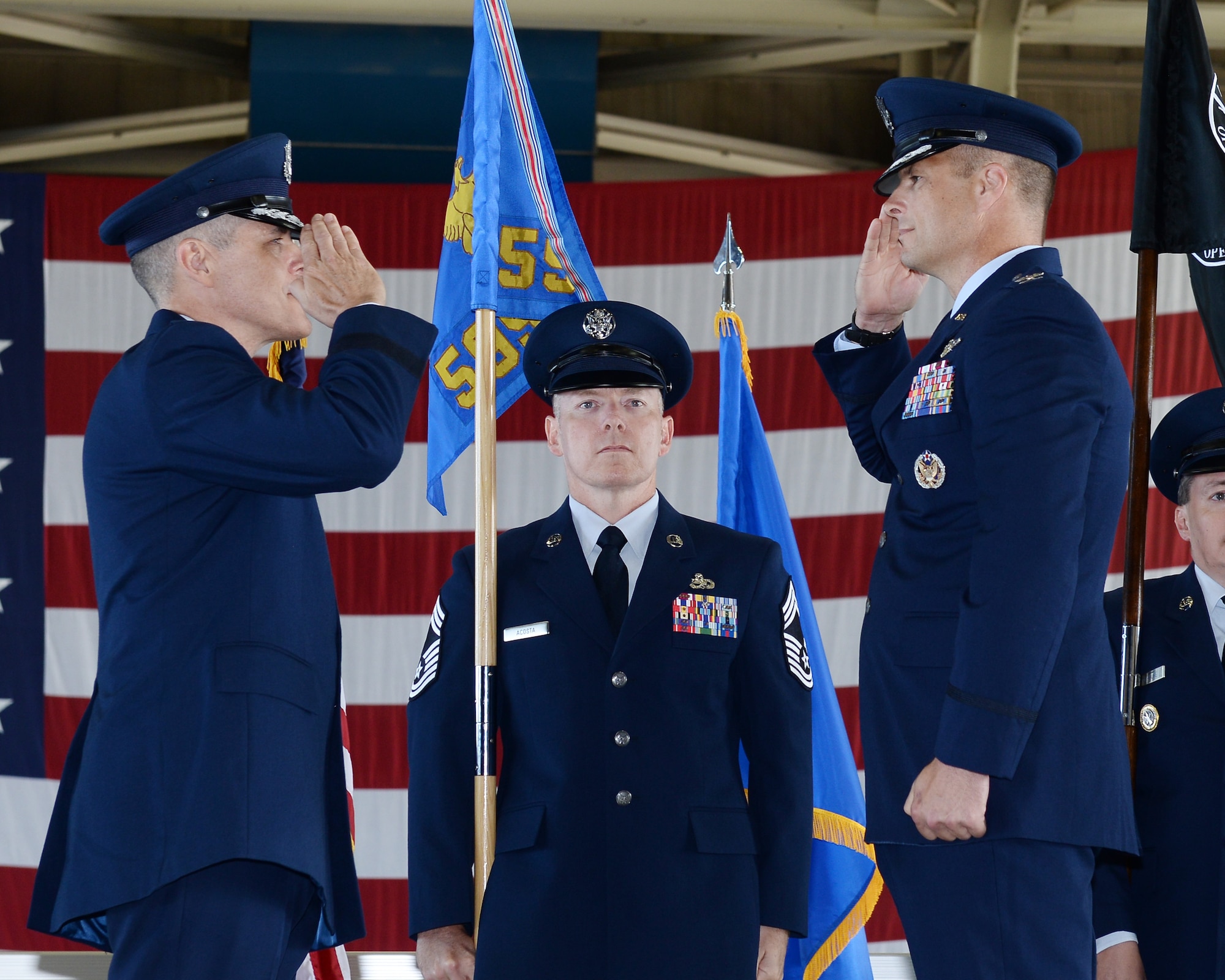 U.S. Air Force Maj. Gen. Thomas Bussiere, Eighth Air Force and Joint-Global Strike Operations Center commander (left) and U.S. Air Force Col. Jeremiah Baldwin, incoming 595th C2G commander and National Airborne Operations Center commander (right), exchange salutes during the dual-595th Command and Control Group and NAOC change of command ceremony July 27, 2018, at Offutt Air Force Base, Nebraska as a single commander assumed responsibility for both organizations. (U.S. Air Force photo by Charles Haymond)