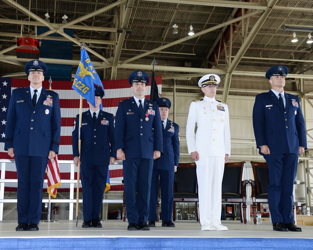 U.S. Air Force Maj. Gen. Thomas Bussiere, Eighth Air Force and Joint-Global Strike Operations Center commander; U.S. Air Force Col. Robert Billings, outgoing 595th C2G commander, U.S. Navy Capt. Dennis Crews, outgoing NAOC commander; and U.S. Air Force Col. Jeremiah Baldwin, incoming 595th C2G commander and NAOC commander (from left to right), stand at attention during the dual-595th Command and Control Group and National Airborne Operations Center change of command ceremony July 27, 2018, at Offutt Air Force Base, Nebraska as a single commander assumed responsibility for both organizations. (U.S. Air Force photo by Charles Haymond)