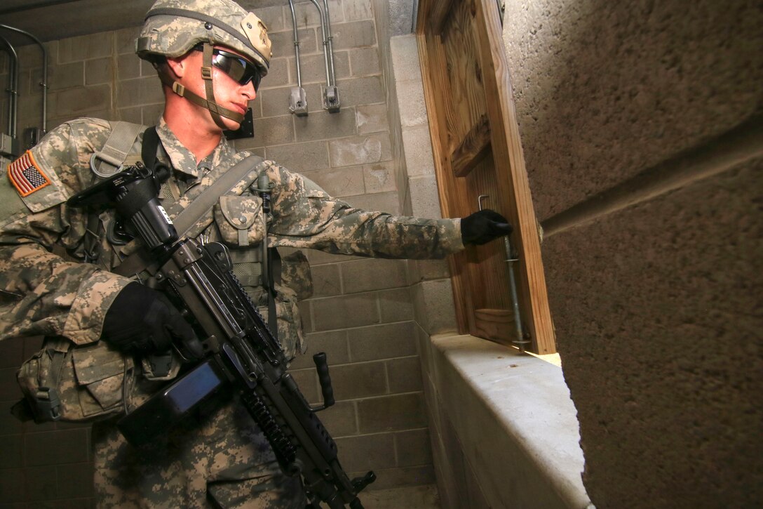 A soldier searches a building for enemy combatants.