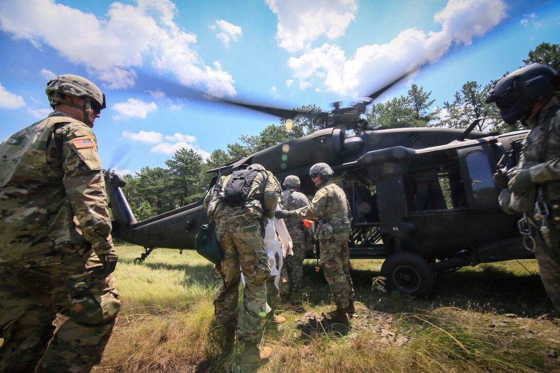 Soldiers load onto an Army UH-60L Black Hawk helicopter after conducting air assault training.
