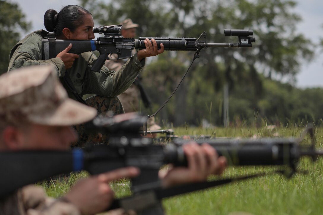 U.S. Marine Corps Staff Sgt. Estefania Patino, Primary Marksmanship Instructor, corrects the rifle combat optic of a recruit’s weapon during grass week June 6th, 2018, on Parris Island, S.C. The purpose of grass week is to teach recruits shooting positions and weapon safety rules for Table 1 and 2. Alpha and Oscar Companies are scheduled to graduate July 20th, 2018.