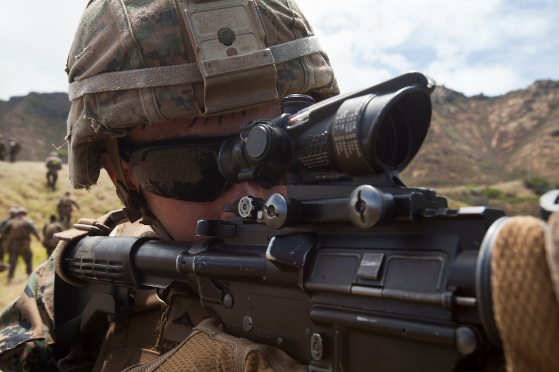 U.S. Marine Corps Lance Cpl. Wyatt Prettyman, a squad leader with Lima Company, 3rd Battalion, 3rd Marine Regiment, III Marine Expeditionary Force, provides rear security after a fire team assault at the Kaneohe Bay Range Training Facility, Marine Corps Base Hawaii, July 26, 2018. Riflemen utilized their individual weapon systems such as the M203 Grenade Launcher, M72 Light Anti-Tank Weapon, M4A1 Assault Rifle and the M27 Infantry Automatic Rifle to conduct a fire team assault. Marines with India, Kilo and Limo Company worked together to improve their communication, leadership and lethality as a fire team.