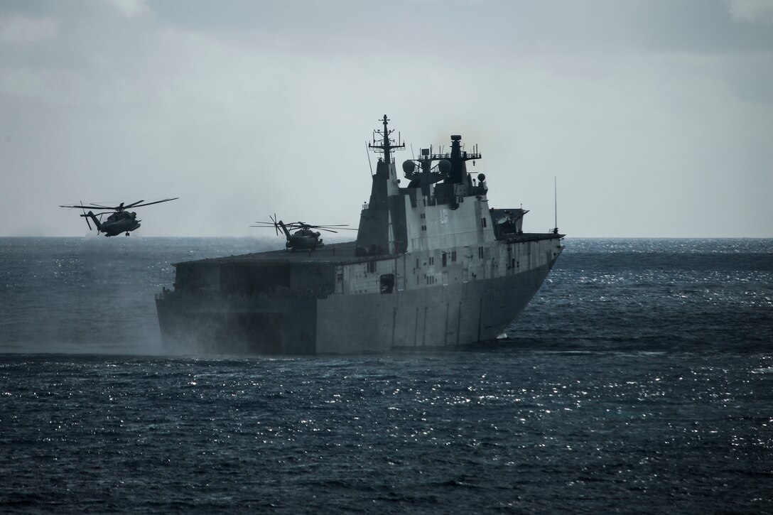 Two CH-53E Super Stallion helicopters assigned to Marine Heavy Helicopter Squadron 463 land aboard the Royal Australian Navy landing helicopter dock ship HMAS Adelaide during an amphibious landing demonstration as part of Rim of the Pacific exercise at Pyramid Rock Beach on Marine Corps Base Hawaii July 29, 2018. RIMPAC provides high-value training for task-organized, highly capable Marine Air-Ground Task Force and enhances the critical crisis response capability of U.S. Marines in the Pacific. Twenty-five nations, 46 ships, five submarines, about 200 aircraft and 25,000 personnel are participating in RIMPAC from June 27 to Aug. 2 in and around the Hawaiian Islands and Southern California.