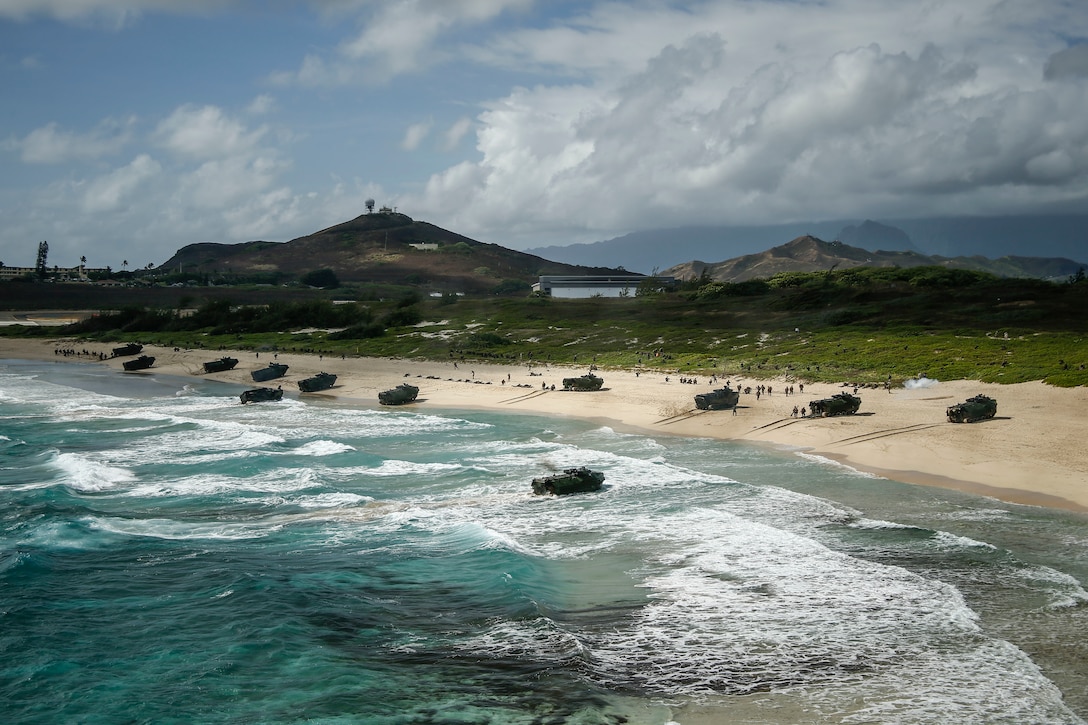 AAV-P7/A1 assault amphibious vehicles assigned to Combat Assault Company, 3rd Marine Regiment, unload service members during an amphibious landing demonstration as part of Rim of the Pacific exercise at Pyramid Rock Beach on Marine Corps Base Hawaii July 29, 2018. RIMPAC provides high-value training for task-organized, highly capable Marine Air-Ground Task Force and enhances the critical crisis response capability of U.S. Marines in the Pacific. Twenty-five nations, 46 ships, five submarines, about 200 aircraft and 25,000 personnel are participating in RIMPAC from June 27 to Aug. 2 in and around the Hawaiian Islands and Southern California.