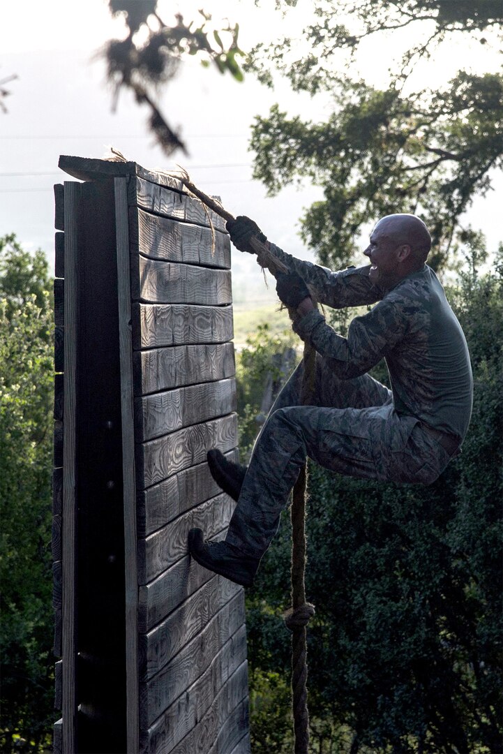 Capt. Nathan Spradley, 902nd Security Forces Squadron operations officer, climbs an obstacle July 23 at Joint Base San Antonio-Camp Bullis in preparation for the 2018 Defender Challenge. The competition will pit security forces teams against each other in realistic weapons, dismounted operations and relay challenge events.