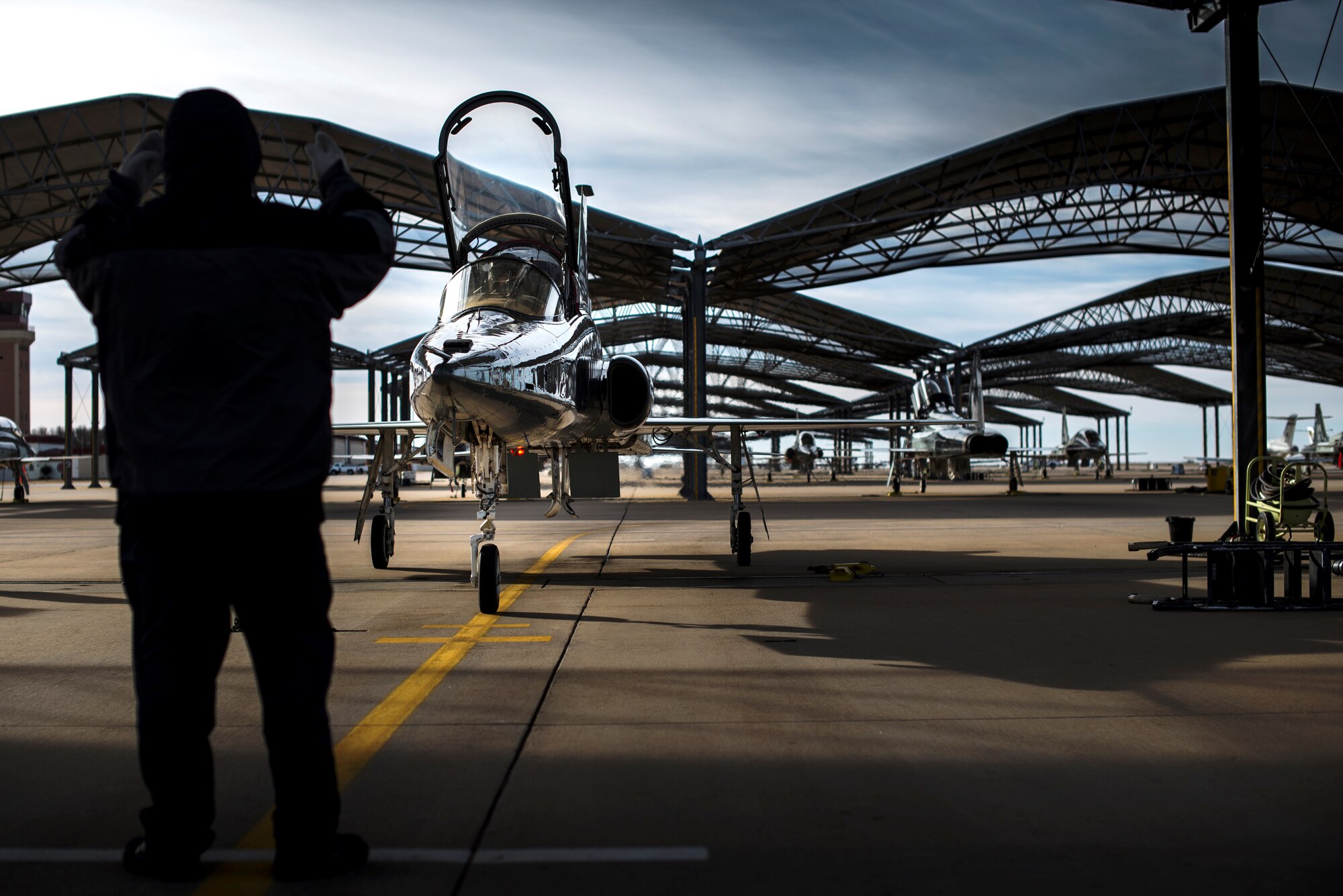 An L3 Maintenance contractor directs a T-38C Talon to its parking spot Feb. 1 at Vance Air Force Base, Oklahoma. The T-38 is a two-seat, twinjet supersonic jet trainer. It was the world's first supersonic trainer and is also the most produced.