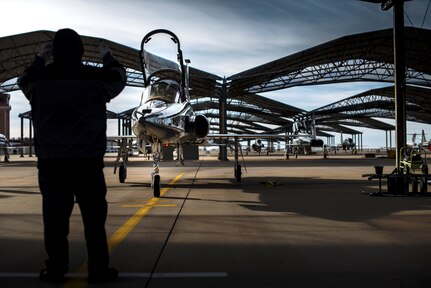 An L3 Maintenance contractor directs a T-38C Talon to its parking spot Feb. 1 at Vance Air Force Base, Oklahoma. The T-38 is a two-seat, twinjet supersonic jet trainer. It was the world's first supersonic trainer and is also the most produced.