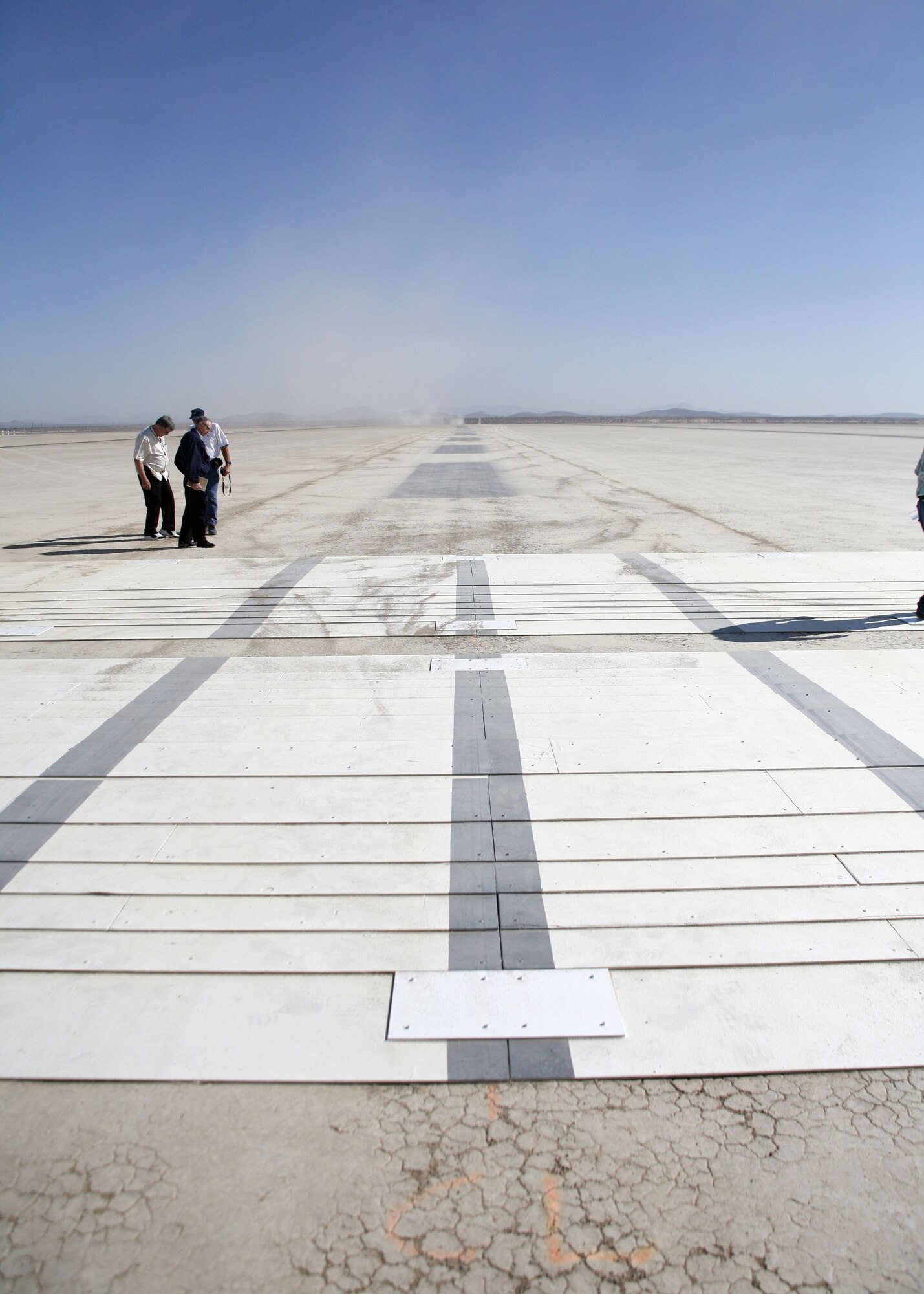 A C-5 Galaxy taxis across a series of ramps on Rogers Dry Lakebed here August 2 as part of the C-5�s Reliability Enhancement and Re-Engining Program. The dynamic tests are designed to evaluate the structural modes of the aircraft with newer CF6 jet engines installed.  (Photo by Jet Fabara)