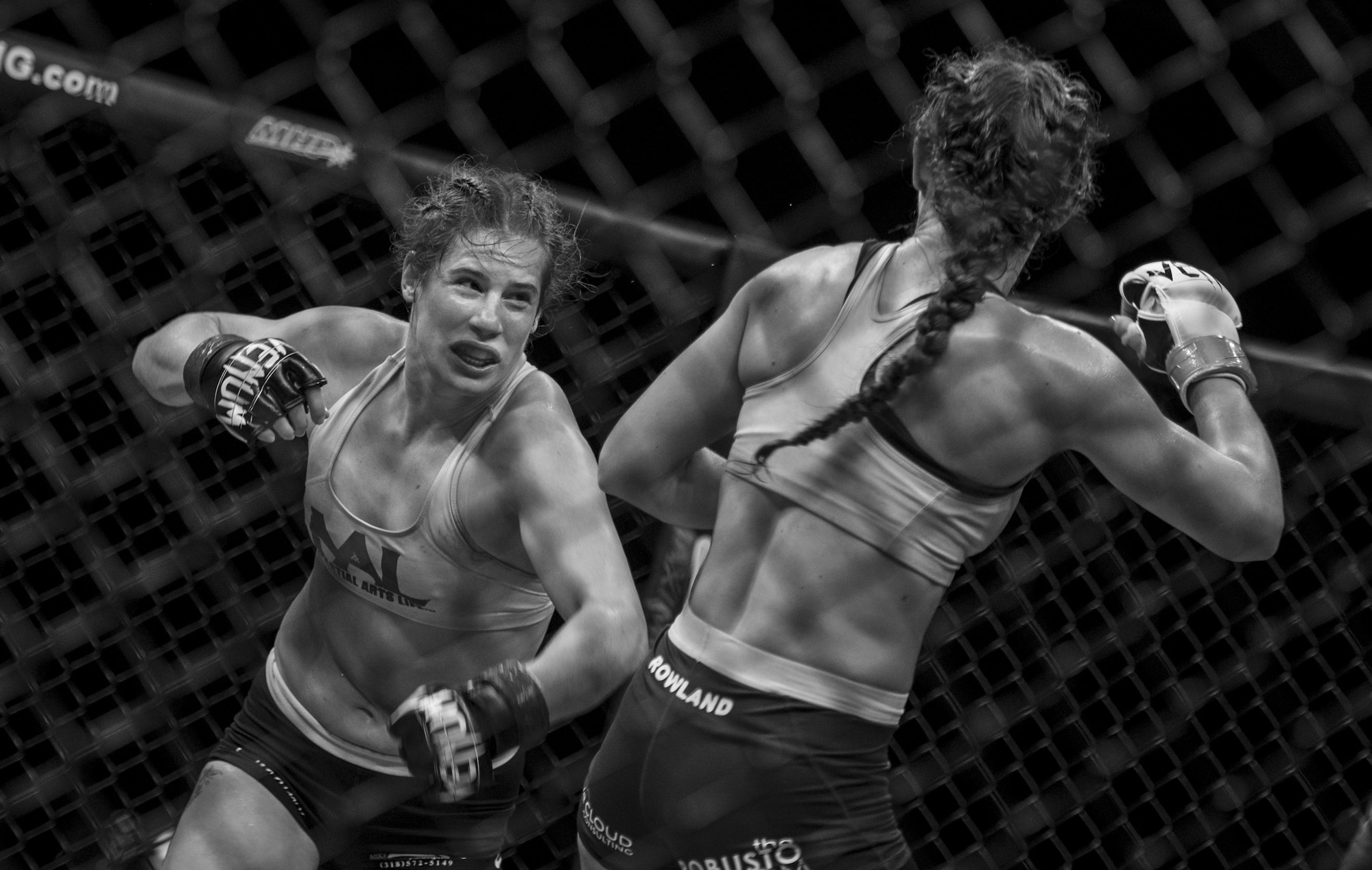 Left, Victoria Leonardo and Salina Rowland, mixed martial art athletes, fight during the Legacy Fighting Alliance live broadcast at Joint Base Langley-Eustis, Virginia, July 27, 2018.