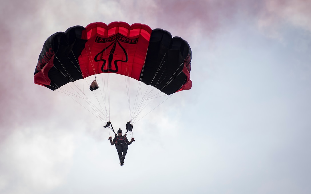 A U.S. Army Special Operations Command Black Daggers Parachute Demonstration Team member parachutes down to the drop zone during the Fort Eustis 100th Anniversary Open House at Joint Base Langley-Eustis, Virginia, July 28, 2018.