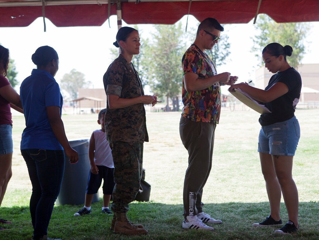 U.S. Marine Corps Sgt. DominiQ Smith, Deputy Family Readiness Officer, takes the votes for favorite chili during the Headquarters and Headquarters Squadron “Chili Cook-Off and three point shootout” at Marine Corps Air Station Miramar, Calif., July 27.  The event was hosted by the H&HS as part of the monthly “Warrior Challenge” competition, bringing the unit together through various events throughout the year.