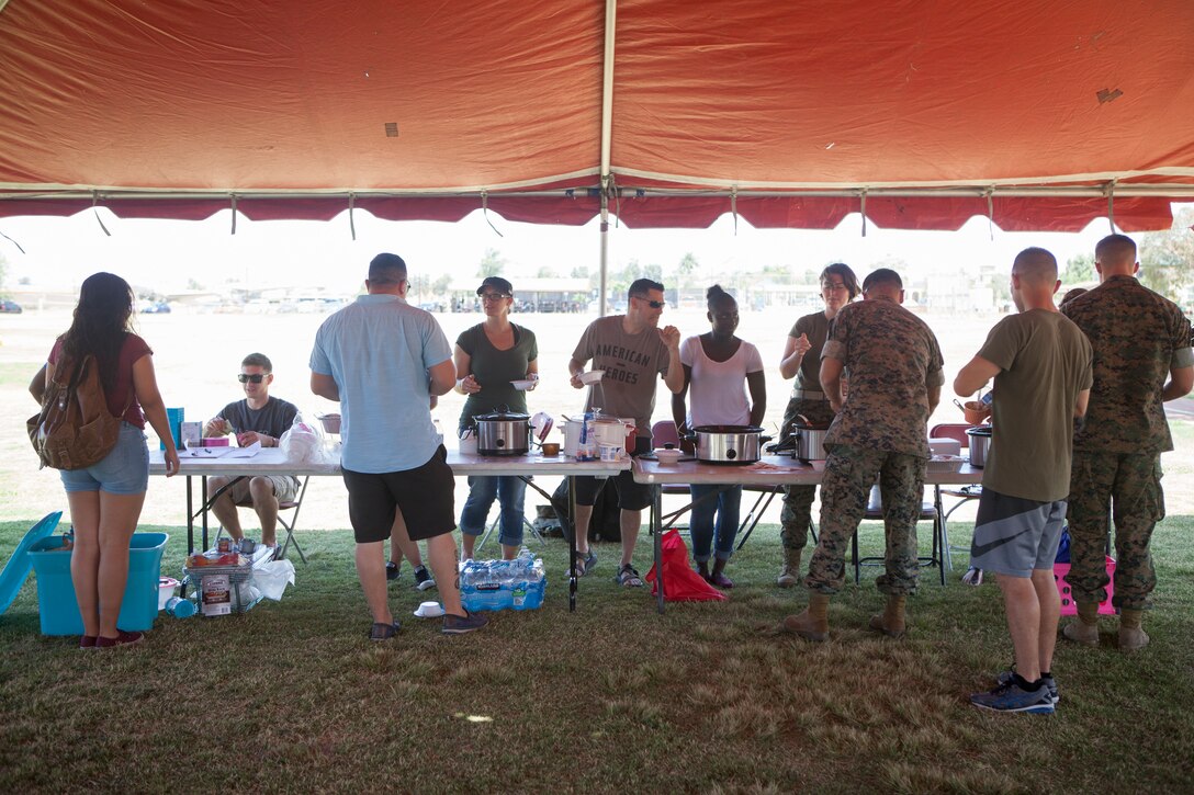 Participants serve chili during the Headquarters and Headquarters Squadron “Chili Cook-Off and three point shootout” at Marine Corps Air Station Miramar, Calif., July 27.  The event was hosted by the H&HS as part of the monthly “Warrior Challenge” competition, bringing the unit together through various events throughout the year.