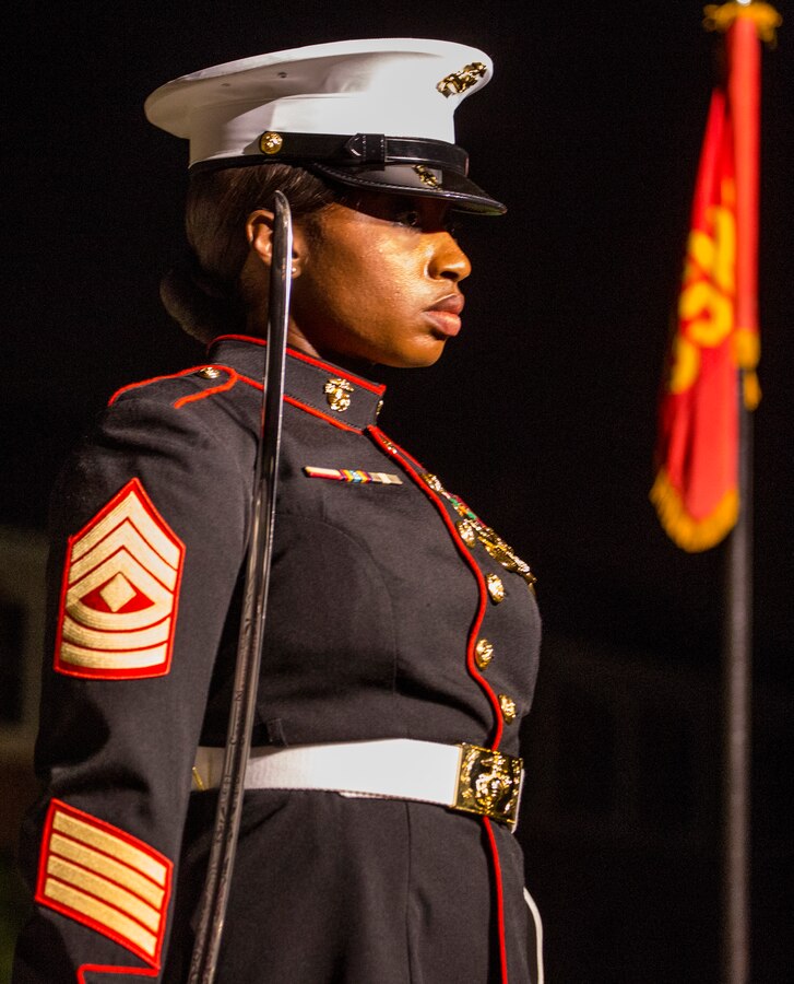 First Sgt. Giselle Calliste, company first sergeant, Guard Company, Marine Barracks Washington D.C., marches off Center Walk during the Staff-Noncommissioned Officer Friday Evening Parade at the Barracks, July 27, 2018. During the SNCO Friday Evening Parade, SNCO’s assume the billets of key leaders’ marching positions normally filled by officers and non-commissioned officers. Calliste assumed the position of the Parade Adjutant for the parade.