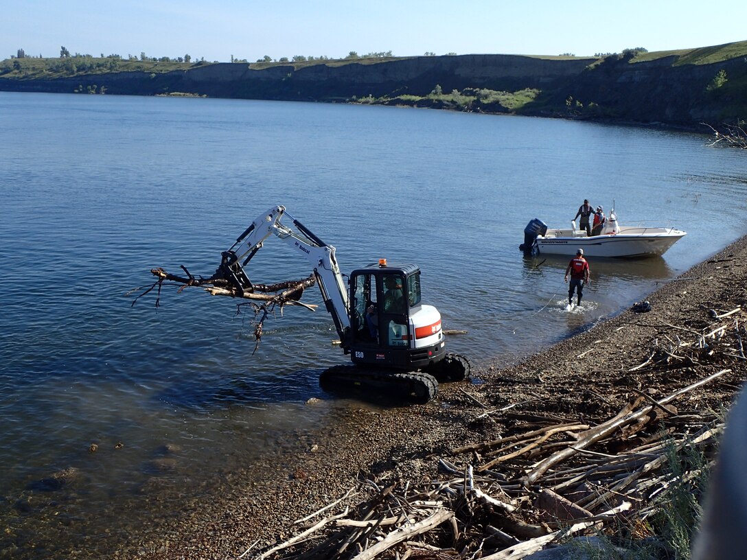 Crews at the Garrison Dam in North Dakota are removing logs and debris from the approach channel and embankment near the spillway.