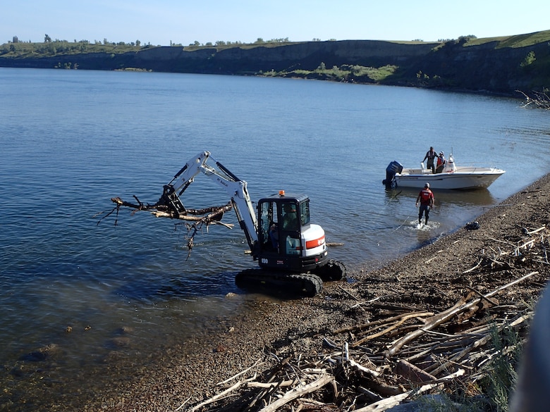 Crews at the Garrison Dam in North Dakota are removing logs and debris from the approach channel and embankment near the spillway.
