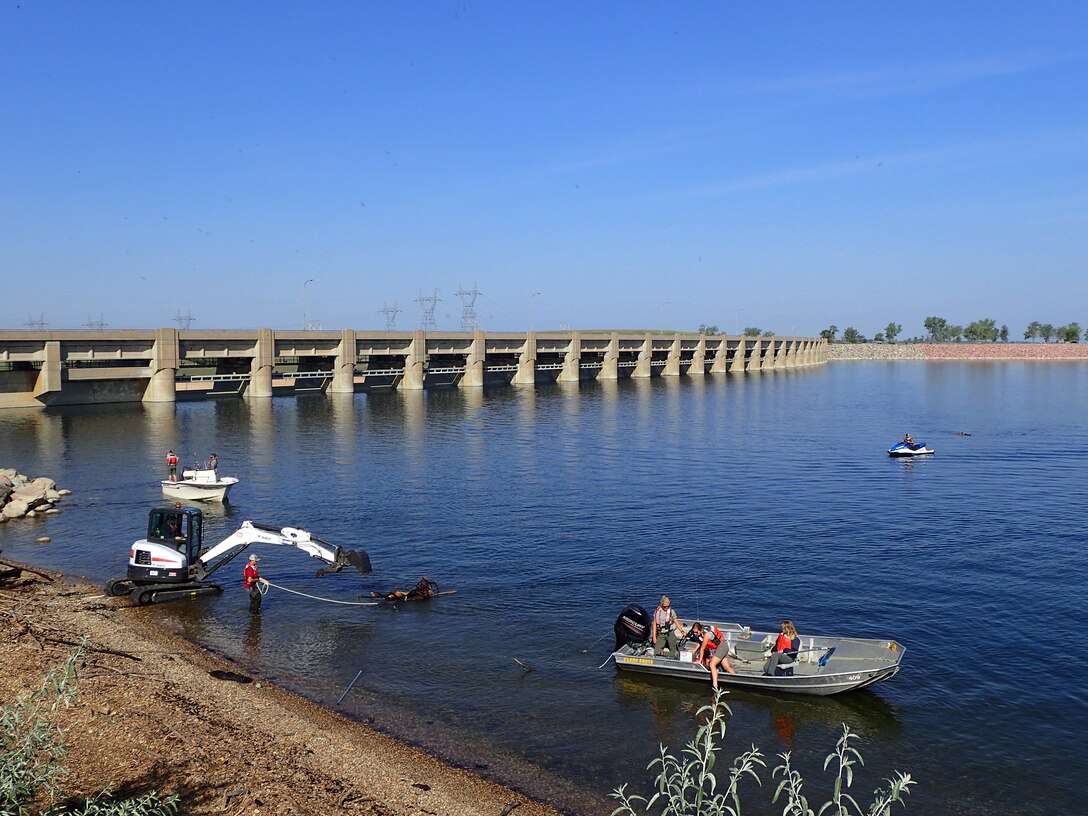 Crews at the Garrison Dam in North Dakota are removing logs and debris from the approach channel and embankment near the spillway.