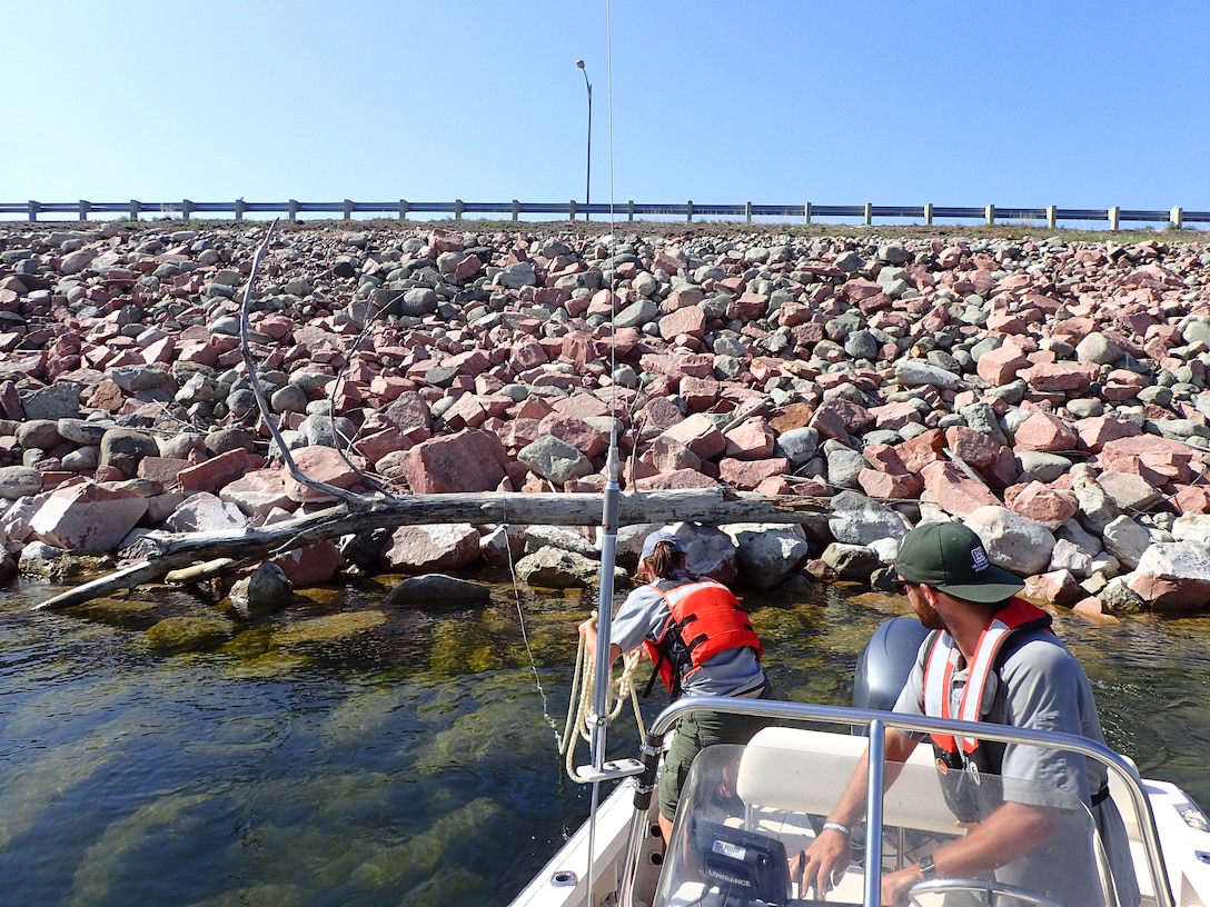 Crews at the Garrison Dam in North Dakota are removing logs and debris from the approach channel and embankment near the spillway.