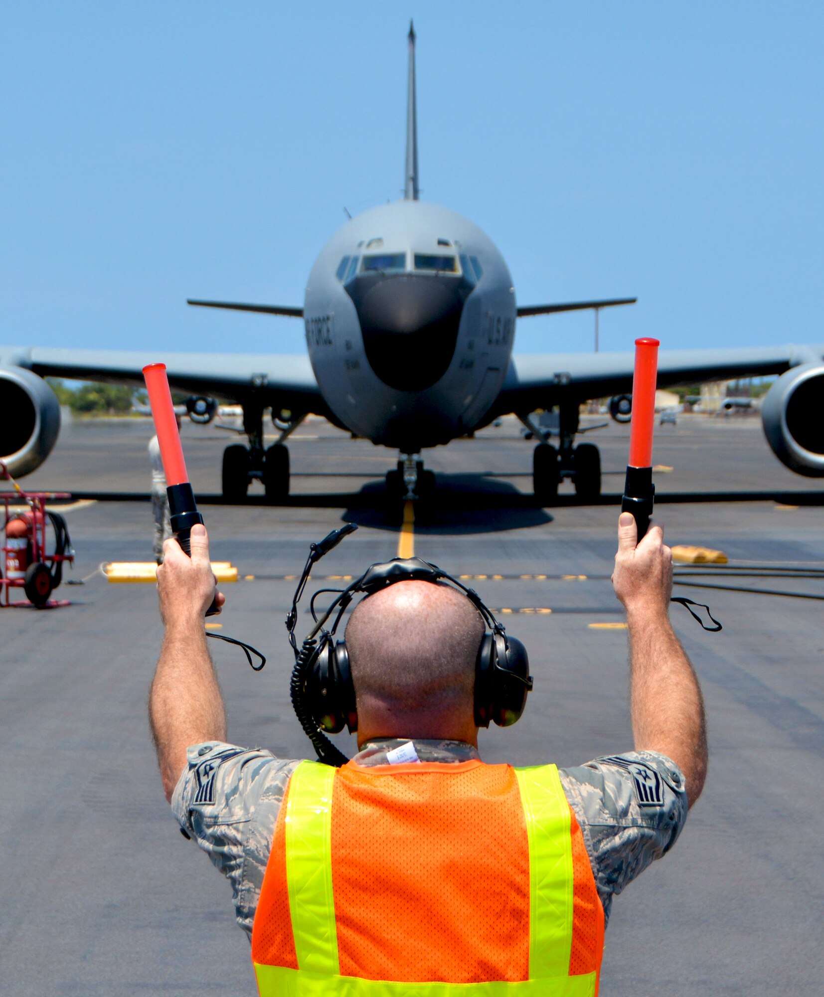 Staff Sgt. Donnie Walters, 507th Aircraft Maintenance Squadron crew chief from Tinker Air Force Base, Oklahoma, marshalls in a 97th Air Mobility Wing KC-135 Stratotanker from Altus Air Force Base, Oklahoma, during the Rim of the Pacific (RIMPAC) exercise July 16. Twenty-five nations, 46 ships, five submarines, and about 200 aircraft and 25,000 personnel are participating in RIMPAC from June 27 to Aug. 2 in and around the Hawaiian Islands and Southern California. The world’s largest international maritime exercise, RIMPAC provides a unique training opportunity while fostering and sustaining cooperative relationships among participants critical to ensuring the safety of sea lanes and security of the world’s oceans. RIMPAC 2018 is the 26th exercise in the series that began in 1971. (U.S. Air Force photo by Tech. Sgt. Samantha Mathison)
