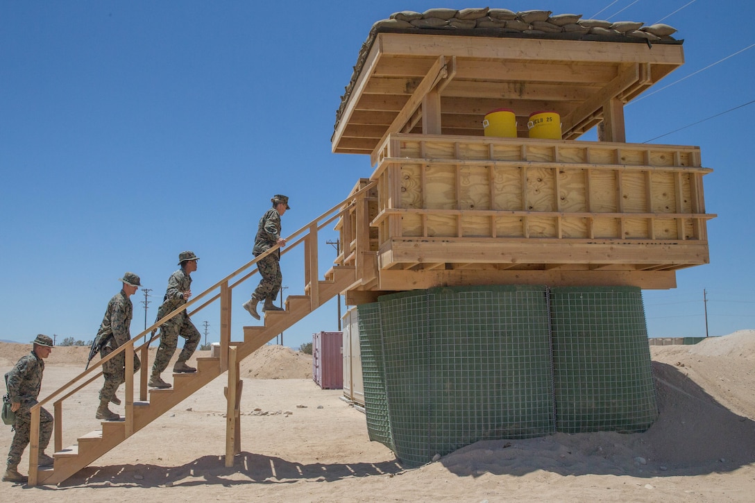 Brig. Gen. Helen G. Pratt, commanding general of 4th Marine Logistics Group, and Sgt. Maj. Lanette N. Wright, sergeant major of 4th MLG,tour the guard towers built during Integrated Training Exercise 4-18 by Combat Logistics Regiment 45.