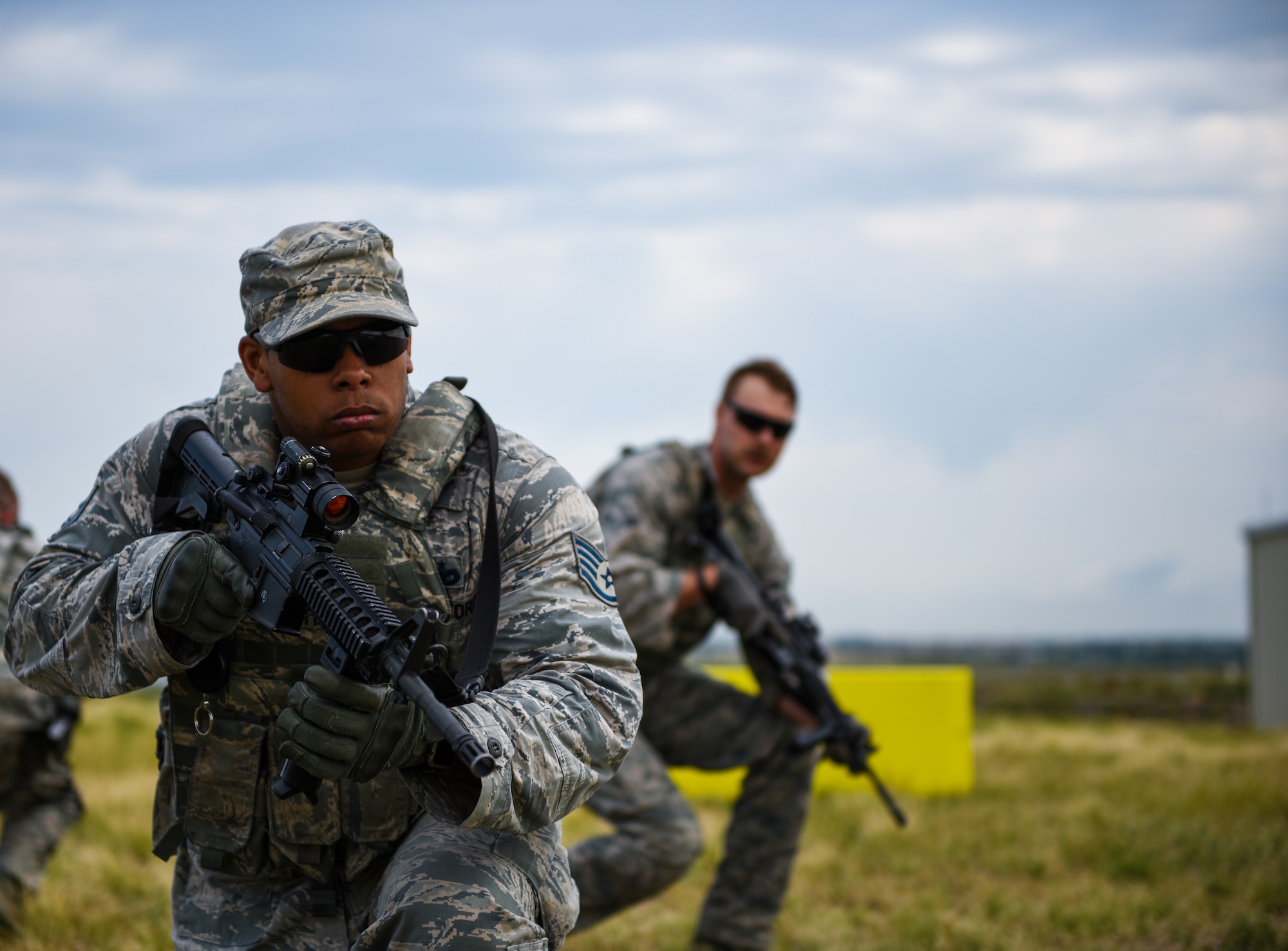 Staff Sgt. Phillip Edwards and Airman 1st Class Austin Cherry, 460th Security Forces Squadron defenders, conduct tactical movements during a field exercise in preparation for the Defenders Challenge July 27, 2018, on Buckley Air Force Base, Colorado. Select Air Force Space Command defenders will compete against one another at Peterson Air Force Base, Colorado, and then winners will compete at Camp Bullis, Texas, for the final challenge.  (U.S. Air Force photo by Airman 1st Class Michael D. Mathews)