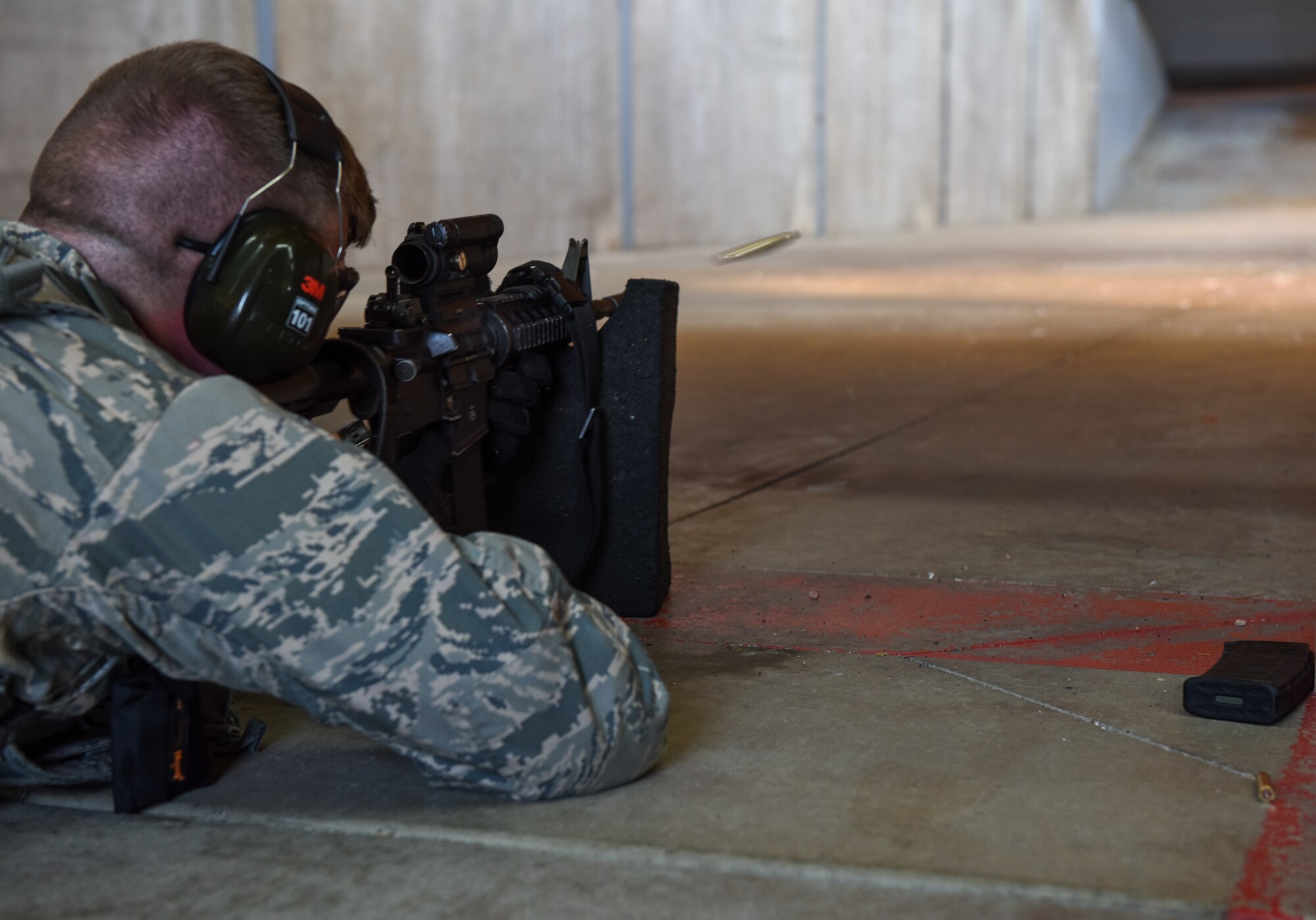 Senior Airman Nicholas Rauch, 460th Security Forces Squadron defender, sends a round into a target in preparation for the Defenders Challenge July 27, 2018, on Buckley Air Force Base, Colorado. Defenders were judged on their accuracy with the M-9 Beretta and M16 rifle during a Defenders Challenge event. (U.S. Air Force photo by Airman 1st Class Michael D. Mathews)
